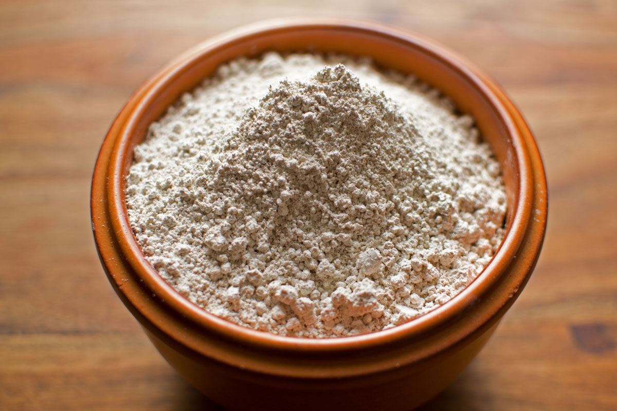 A small brown bowl of Diatomaceous earth