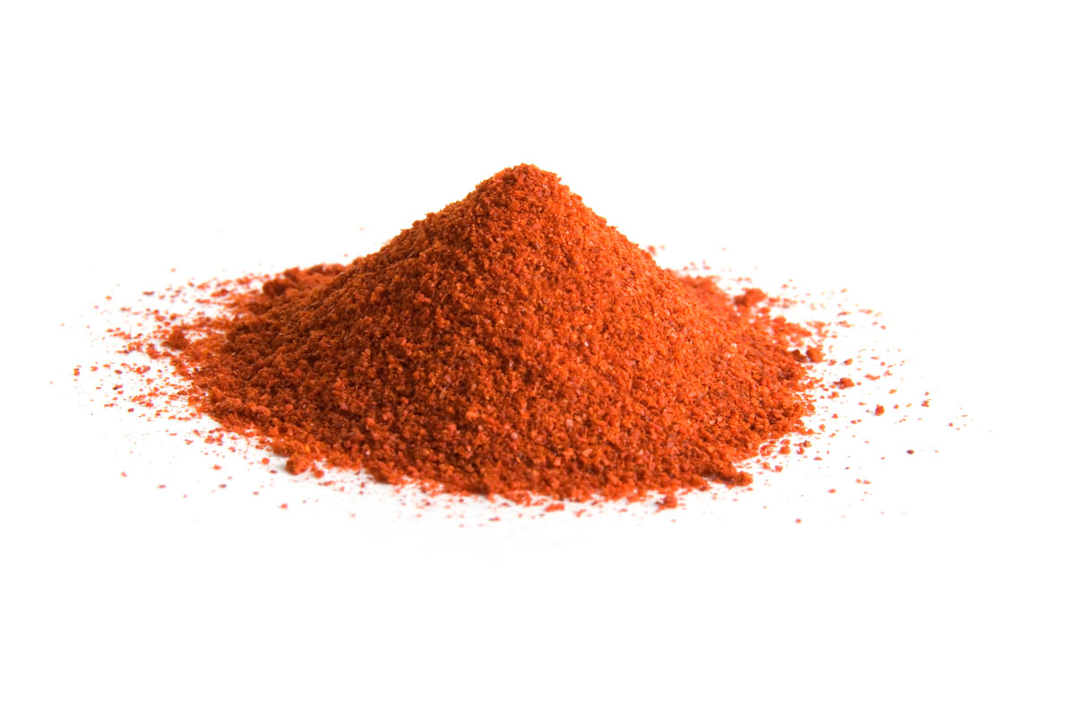 A small pile of Cayenne pepper on a white background