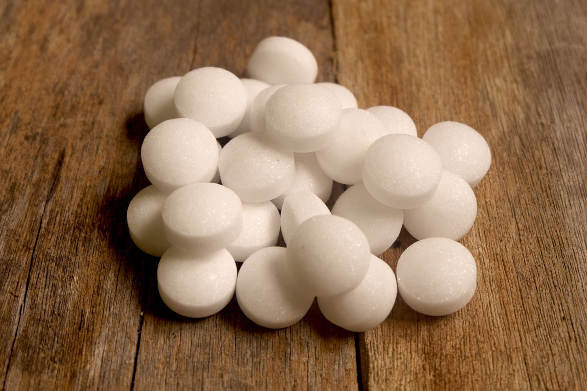 White naphthalene balls on wooden