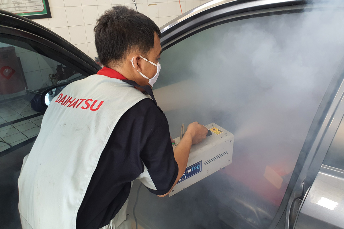 Technician doing Car Air Fogging to Sterilize Car Cabin from Germs, Bacteria, and Viruses